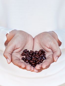 Hand of women holding coffee beans . - Concept for giving refreshing.