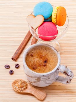 French colourful macaroons and a cup of coffee. - Macro shot with copy space.