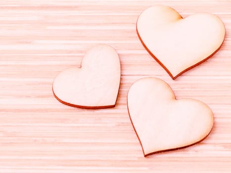 The wooden hearts on wooden background. - Concept for love and wedding .

