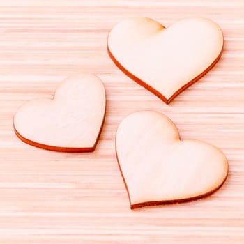 The wooden hearts on wooden background. - Concept for love and wedding .