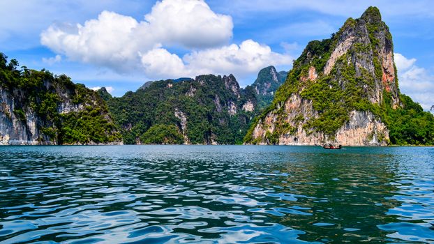 Beautiful scene Blue clear water with rock mountain at Ratchaprapa Dam, Suratthani, Thailand