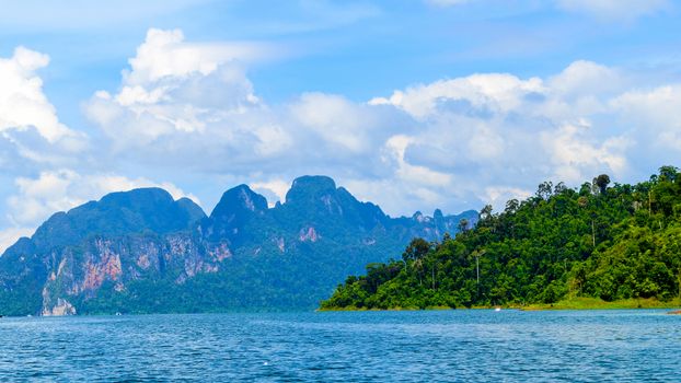 Beautiful scene Blue clear water with rock mountain at Ratchaprapa Dam, Suratthani, Thailand