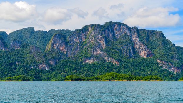 Beautiful scene Blue clear water with rock mountain at Ratchaprapa Dam, Suratthani, Thailand