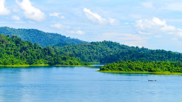 Beautiful scene Blue clear water with rock mountain at Ratchaprapa Dam, Suratthani, Thailand