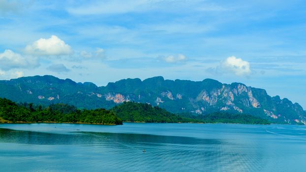 Beautiful scene Blue clear water with rock mountain at Ratchaprapa Dam, Suratthani, Thailand