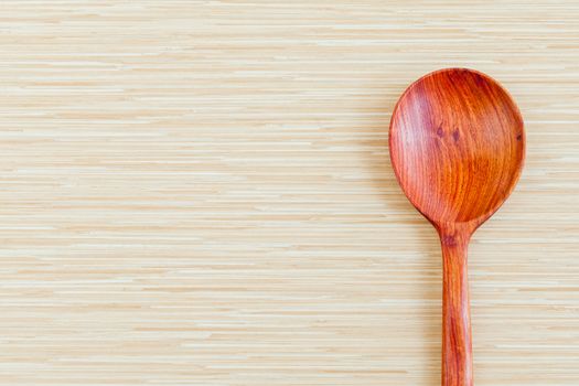 Wooden spoon on wooden background - concept for food and kitchen with copy space.