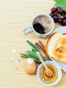 Healthy breakfast toasts and herb on wooden table with copy space.