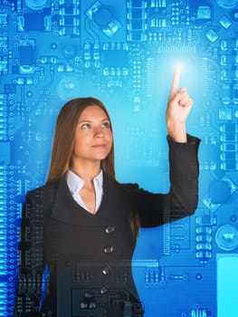 Businesswoman pressing on holographic screen and looking at her finger on abstract motherboard background