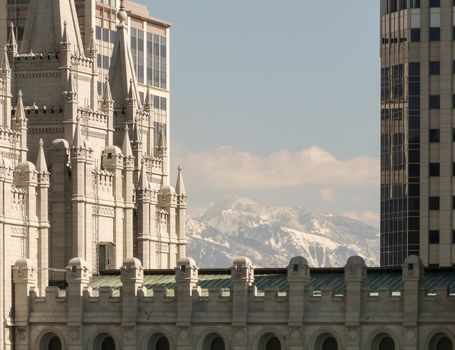 Salt Lake City, UT, USA - May 13, 2008: View at the Salt Lake Temple with snowy mountains at background.