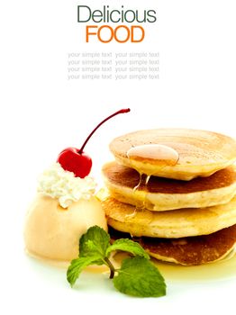 Stack of pancakes with syrup and ice cream.