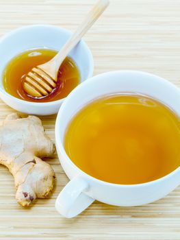 A Cup of ginger tea with honey on wooden background, concept for healthy nutrition.