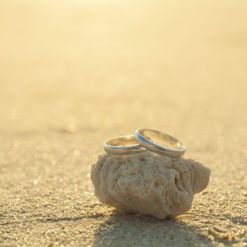 Wedding rings put on the beachside.