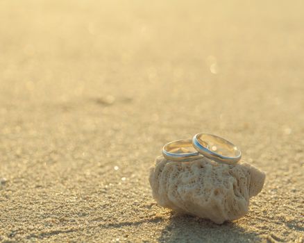 Wedding rings put on the beachside.