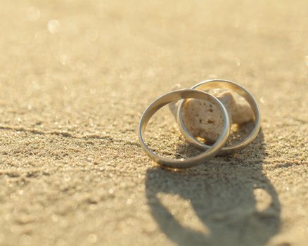 Wedding rings put on the beachside.