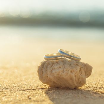 Wedding rings put on the beachside.