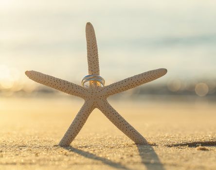 Wedding rings put on the beachside.