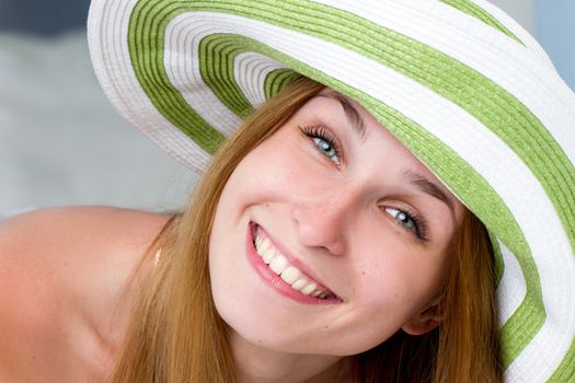 Portrait of pretty cheerful woman wearing straw hat in sunny . Horizontal framing