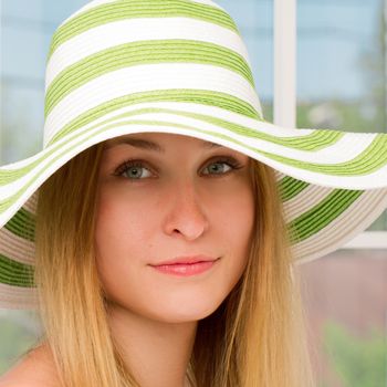 Portrait of pretty cheerful woman wearing straw hat in sunny . square crop