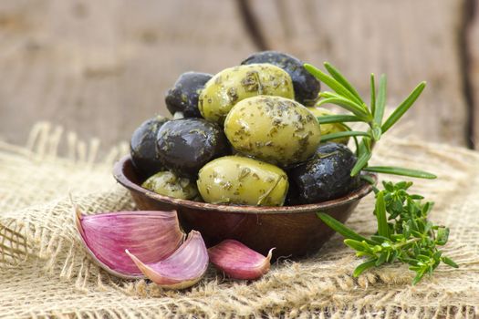 black and green olives marinated with garlic and fresh mediterranean herbs