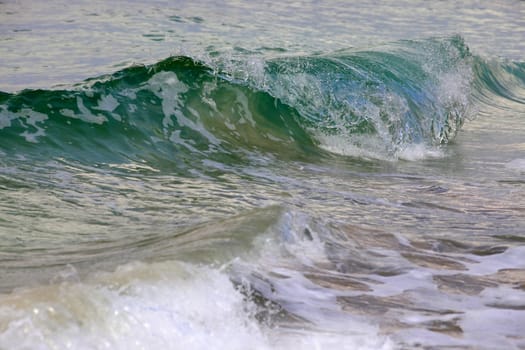 Big wave crashes on to the shore. Mediterranean