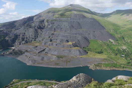 A view looking down to Llyn Peris and the expance of the Dinorwic slate quarry workings on the flank of the mountain Elidir Fawr, Llanberis, Gwynedd, Wales, UK.