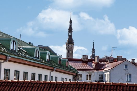 Town and church landscape from Tallinn Walls in Estonia, on blue cloudy background.