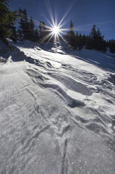 Beautiful winter day on the mountain, sun and snow.