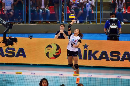 Bangkok, Thailand - July 3, 2015: Wilavan Apinyapong #10 of Thailand serves the ball during the FIVB Volleyball World Grand Prix Thailand and Serbia at Indoor Stadium Huamark on July 3, 2015 in Bangkok, Thailand.