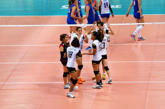 Bangkok, Thailand - July 3, 2015: Thai players celebrates a Thailand point at Indoor Stadium Huamark during the FIVB Volleyball World Grand Prix Thailand and Serbia on July 3, 2015 in Bangkok, Thailand.
