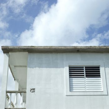 Shutter and window of the side of a modest home 