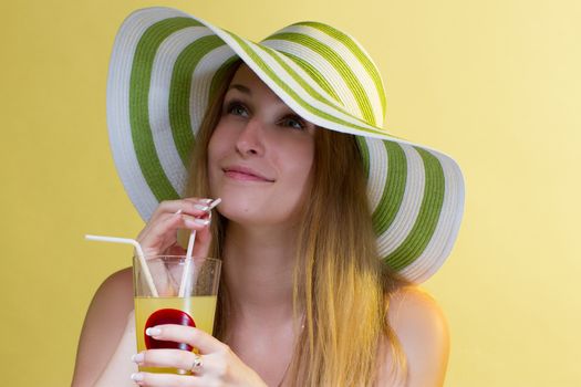 Woman drinking a cocktail over colorful background