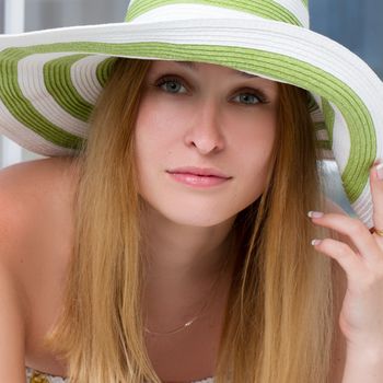 Portrait of pretty cheerful woman wearing straw hat 