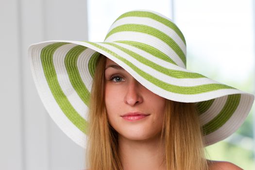 Portrait of pretty cheerful woman wearing straw hat 