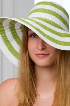 Portrait of pretty cheerful woman wearing straw hat 