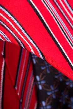 Close up detailed view of multicolored striped and checkered men ties as background.