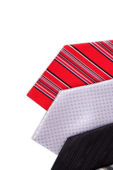 Close up top view of colorful men ties side by side, isolated on white background.