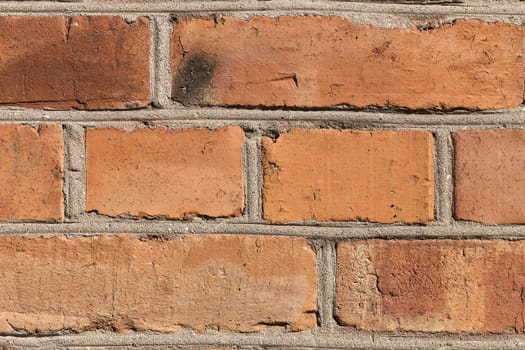 A detailed photo of a brick wall with all the damaged parts and the plaster
