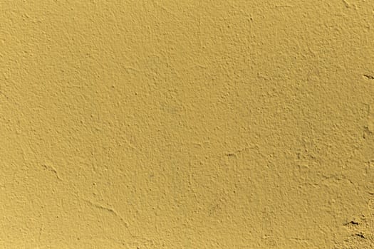 A grained yellow concrete wall with texture