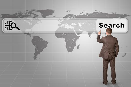 Businessman standing and pressing on browser on abstract grey background with world map, rear view