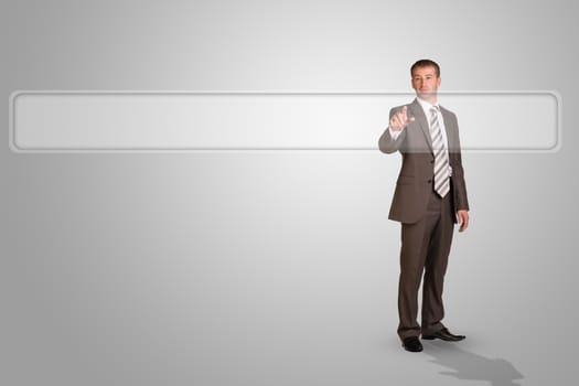 Businessman standing and pressing on holographic screen on abstract grey background, front view