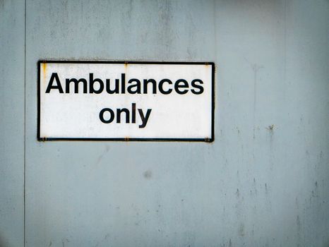 A Grungy Ambulances Only Sign At A Hospital Emergency Room