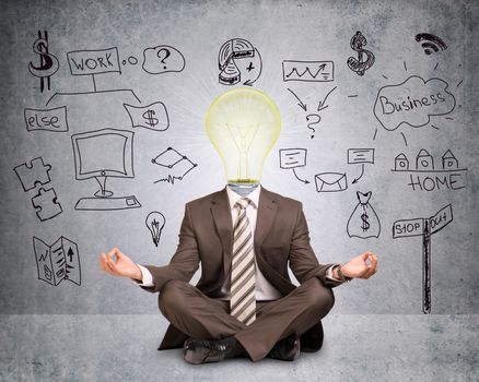Businessman sitting in lotus posture with bulb instead head on abstract grey background with symbols