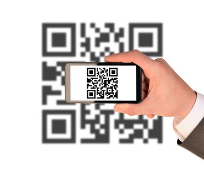 Businessmans hand holding smartphone with QR-code on isolated white background with code