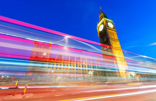 Light trails of Red Bus in front of Big Ben and Westminster Palace.