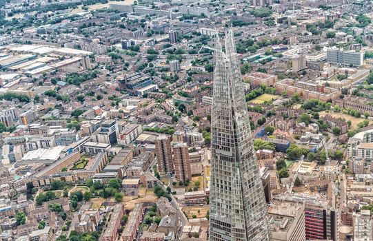 LONDON - JUNE 18, 2015: The Shard and city skyline from helicopter. London attracts 50 million tourists annually.