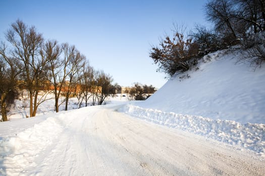   the highway in a winter season. the road is covered with snow