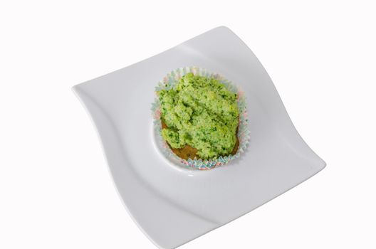 Muffin with fresh fruit and vanilla pod on a light background.