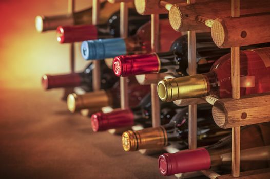 wine bottles stacked on wooden racks shot with limited depth of field