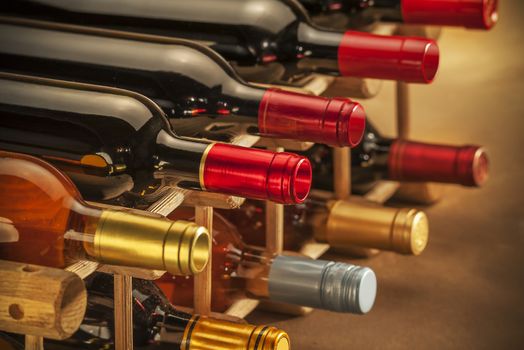 wine bottles stacked on wooden racks shot with limited depth of field