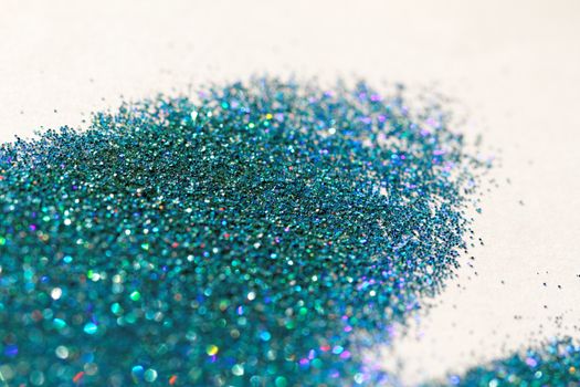 Turquoise glitter on light background - macro photo